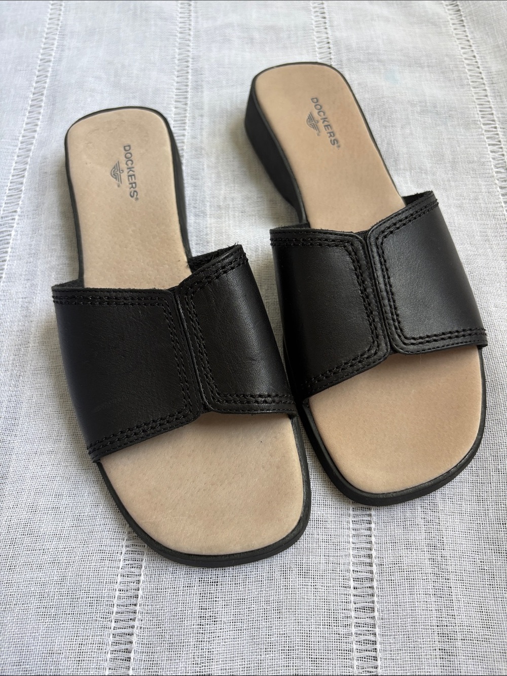 Dockers black slip-on flat sandals with a square open toe and stitched strap